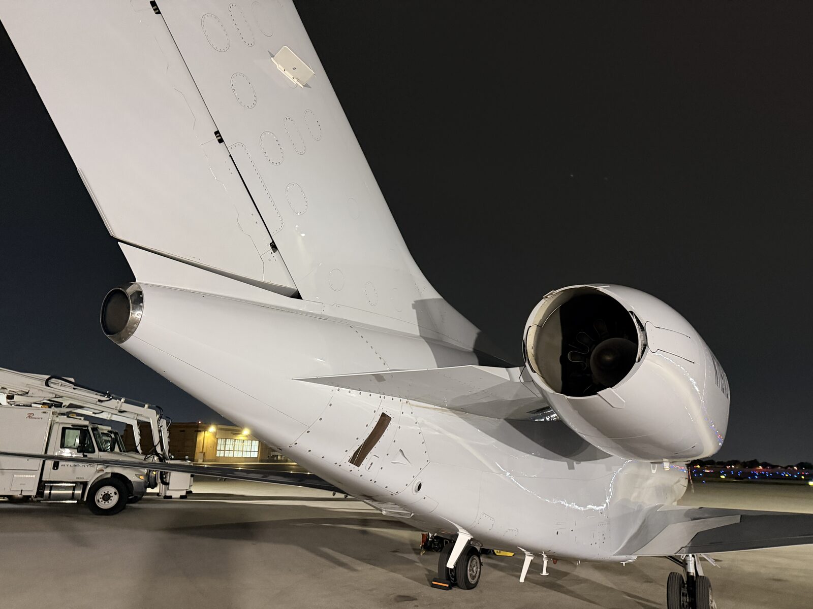 Cessna Citation X tail dual engine nacelles closeup below vertical stabilizer exterior detailing night