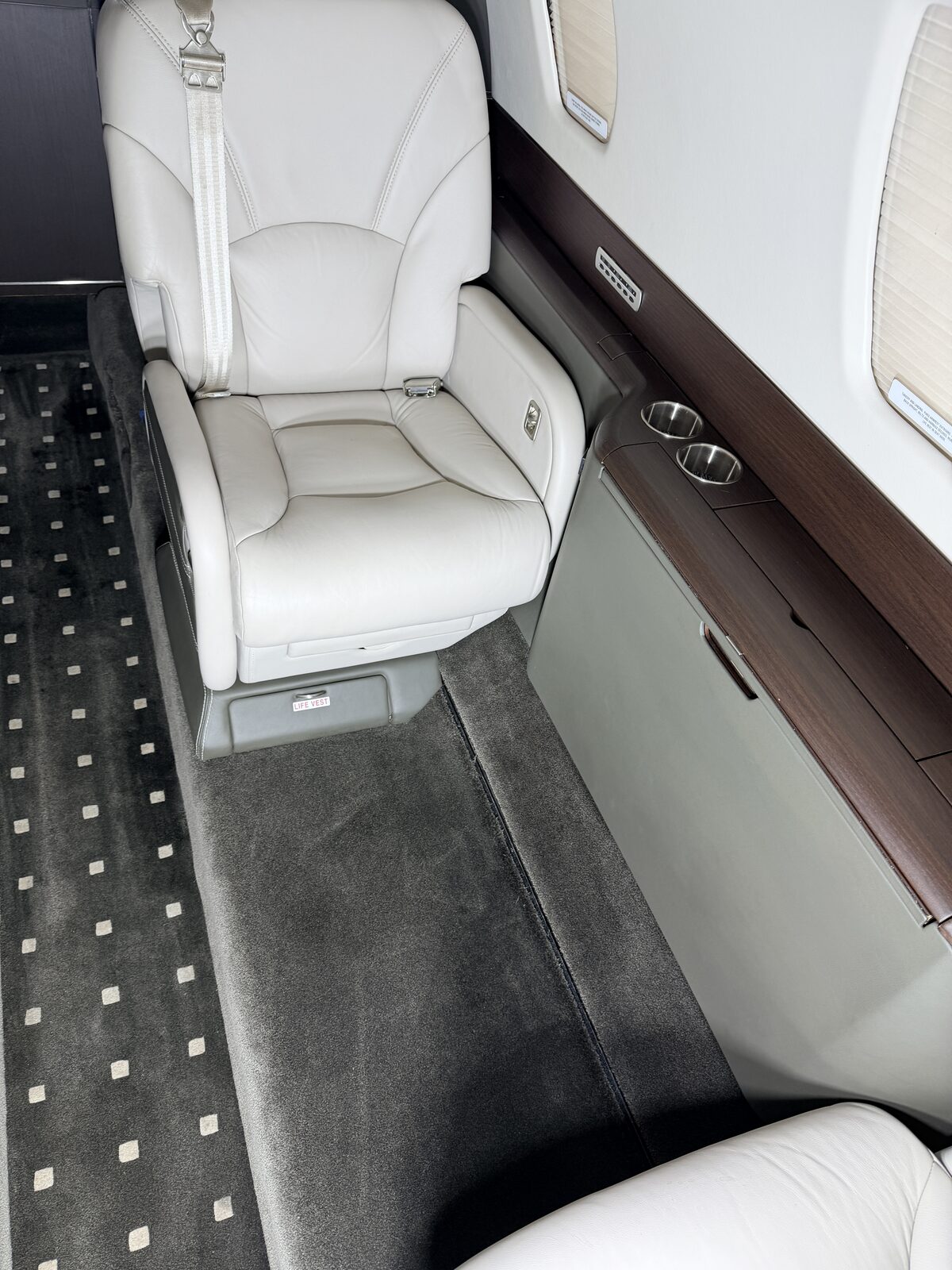 Cessna Citation X interior club seat overhead air vents wood veneer credenza carpet runner detailing