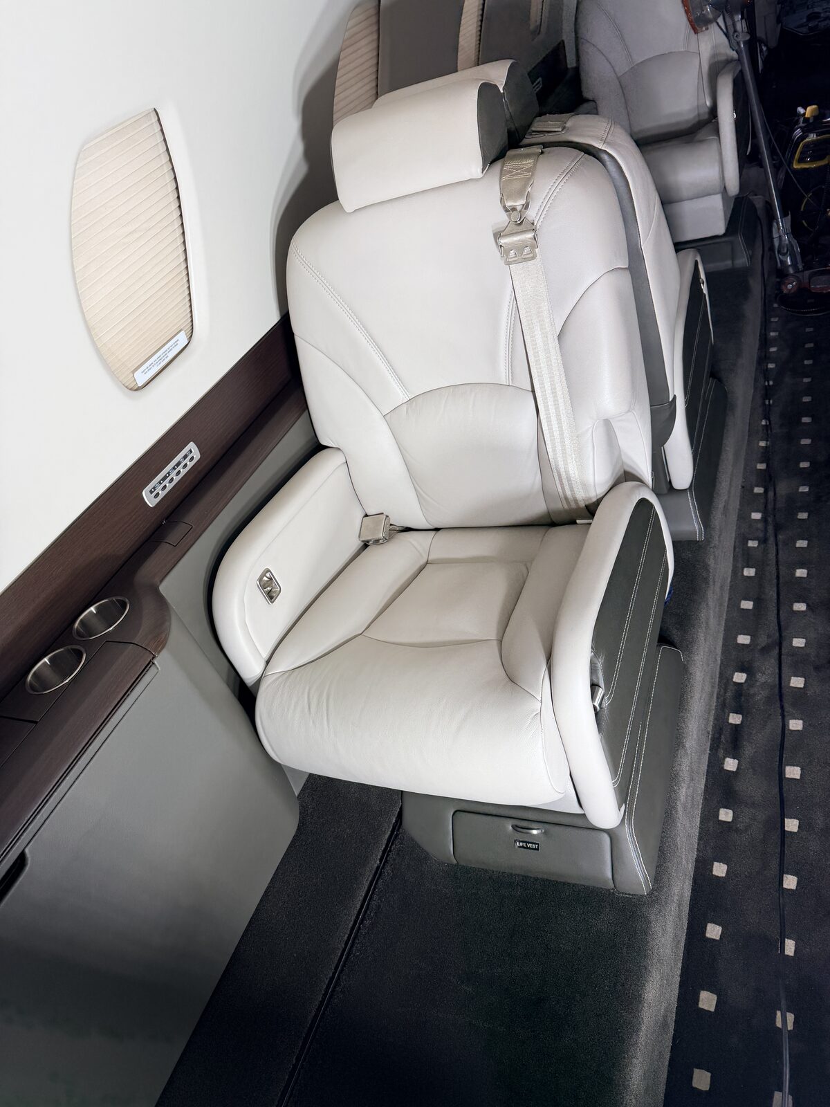 Cessna Citation X interior club seat armrest dark leather accent panel carpet runner window detailing