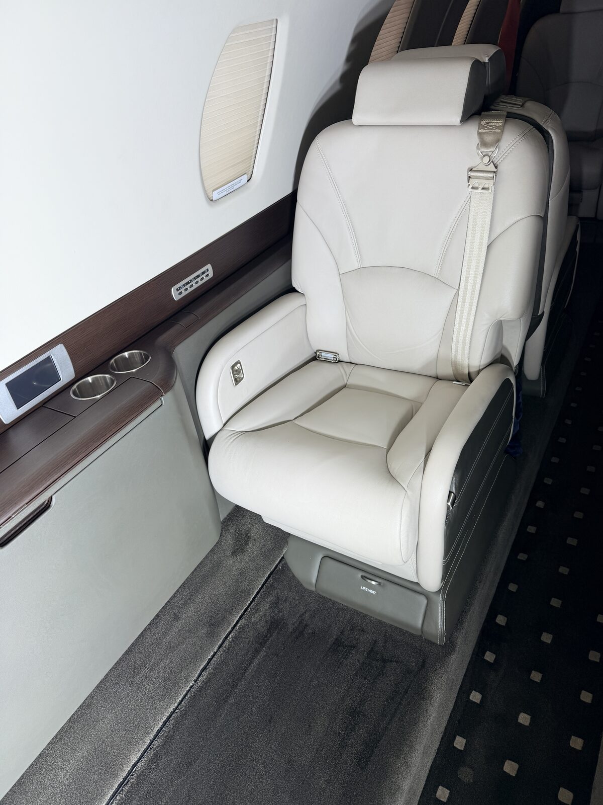 Cessna Citation X interior club seat white leather seatbelt wood veneer table air vents detailing