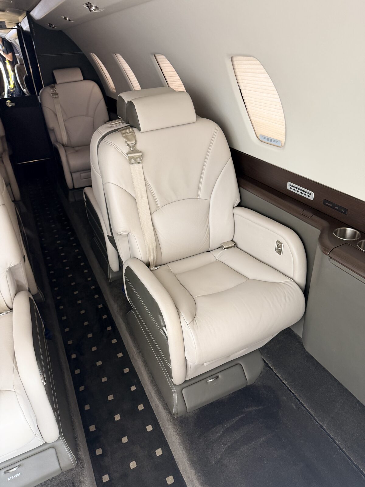 Cessna Citation X interior club seat white leather closeup armrest dark sidewall detailing Chicago