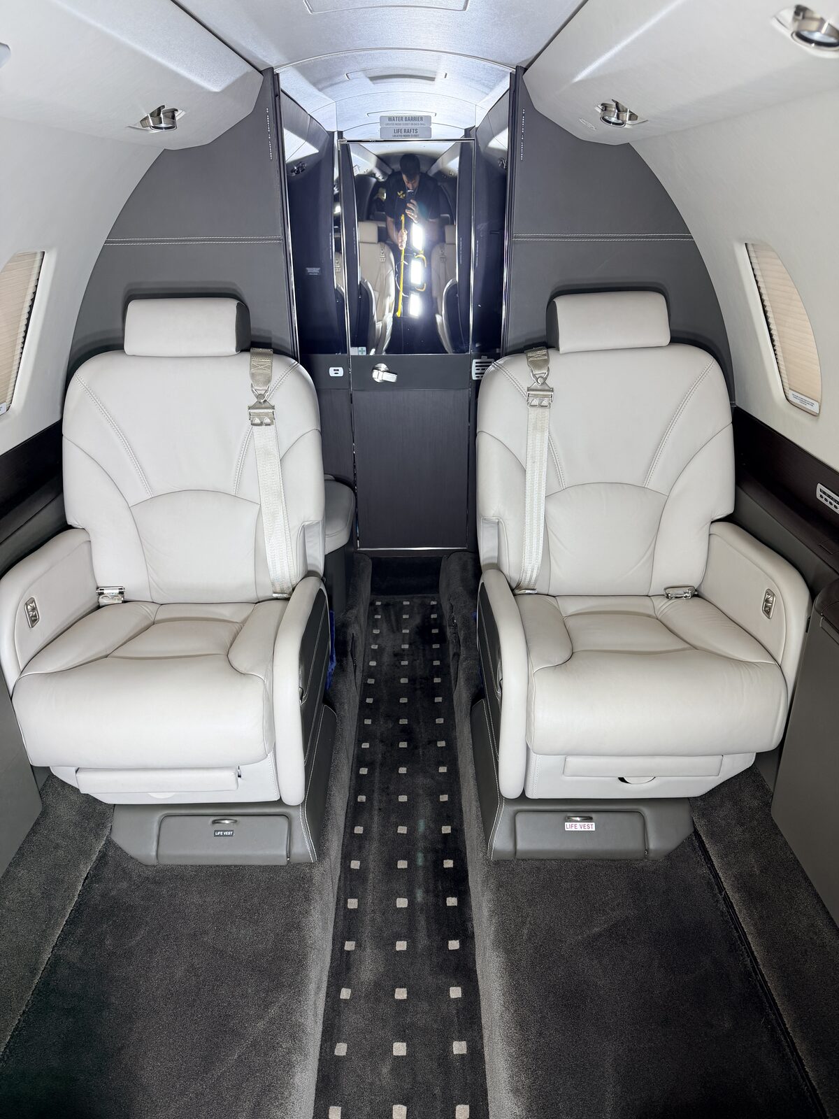 Cessna Citation X interior dual club seats polished dark credenza full cabin view white leather detailing