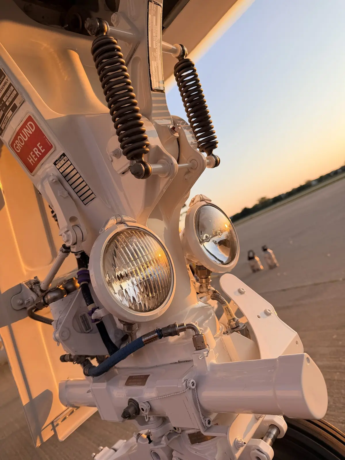 Bombardier Challenger 300 nose gear assembly with taxi and landing lights at sunset after exterior detailing at PWK