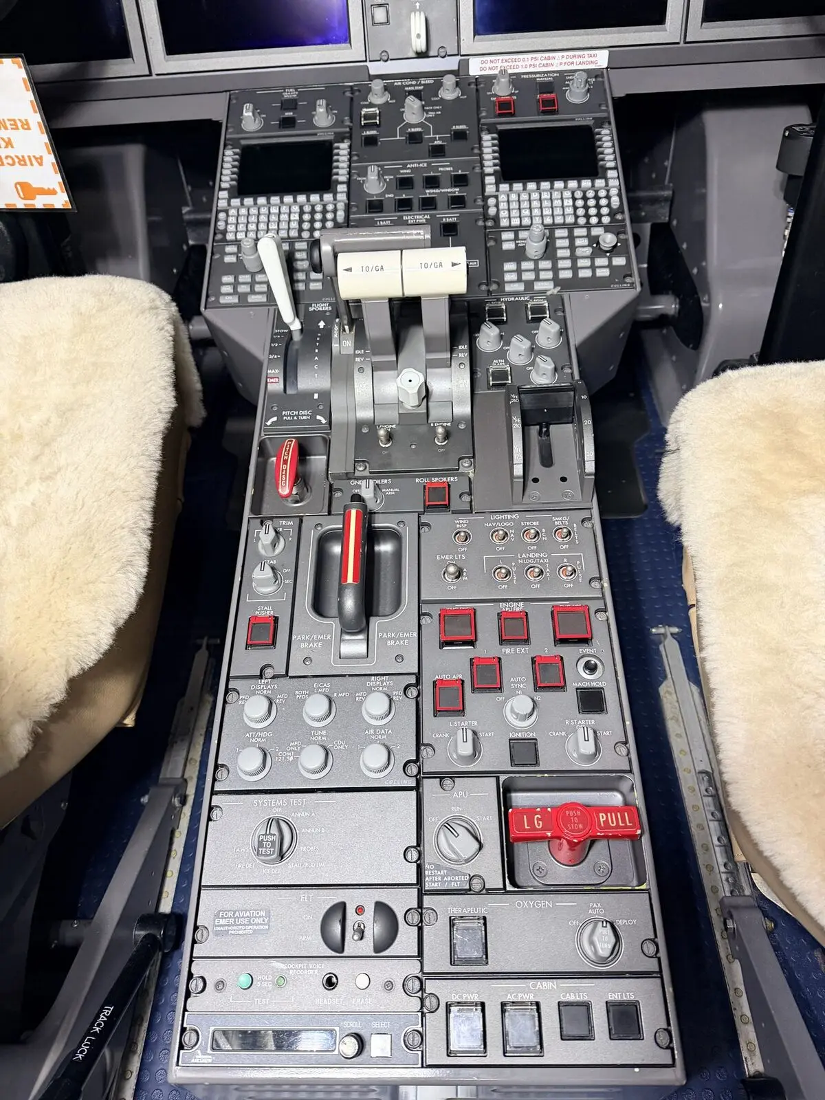 Bombardier Challenger 300 cockpit center pedestal with thrust levers, flap handle, and engine controls after detailing at PWK
