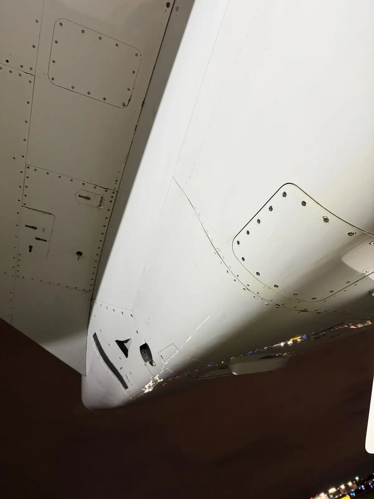 Cessna Citation X horizontal stabilizer and wing root junction after exterior detail at night with ramp lights visible
