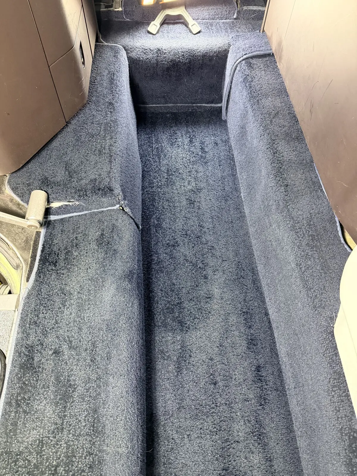 Private jet cabin navy blue aisle carpet looking forward through seats after carpet extraction and interior detailing