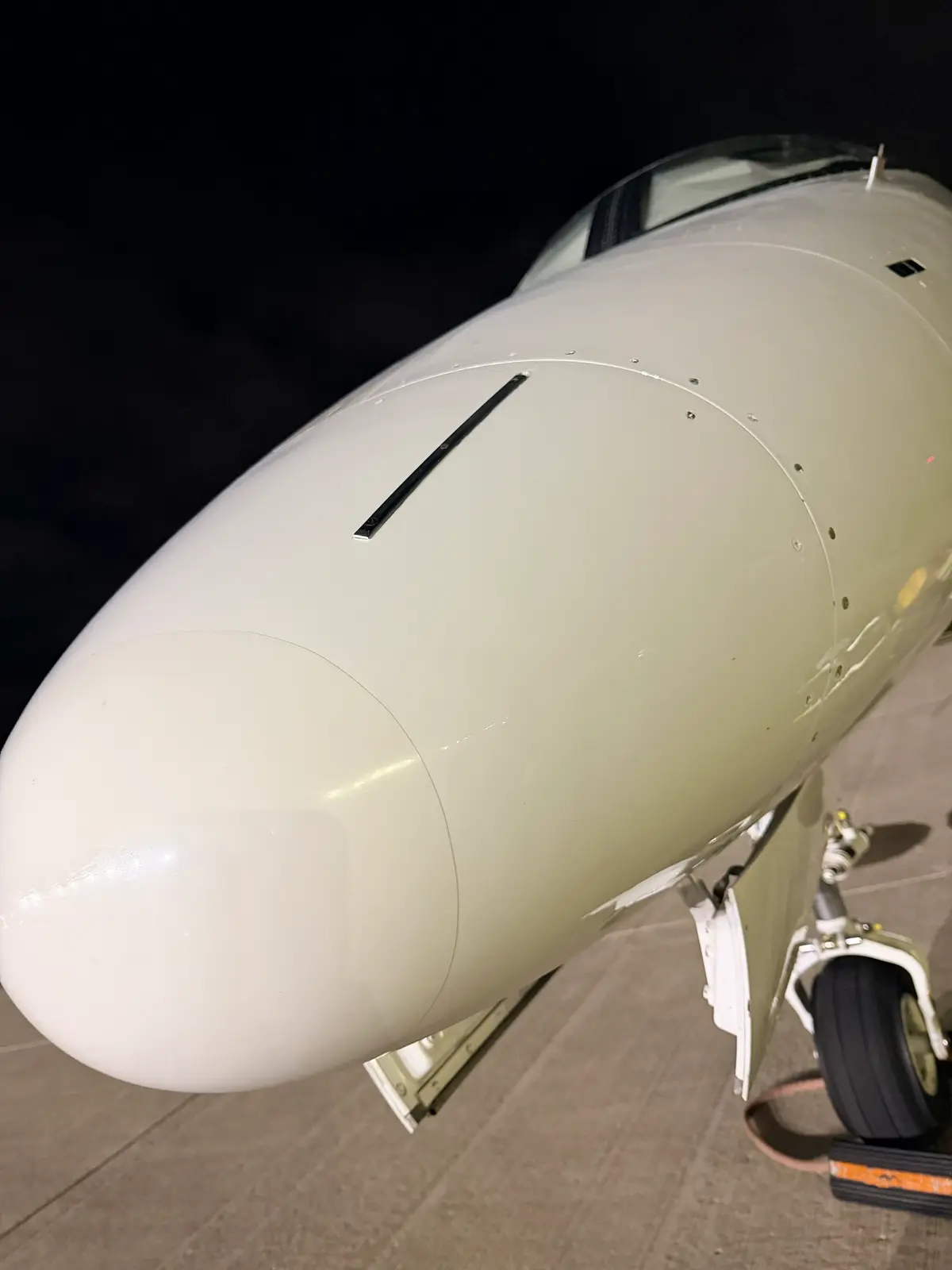 Embraer Phenom 300 polished engine inlet cowl with mirror chrome lip and blue nacelle at night after exterior detailing